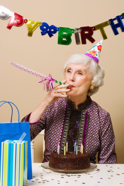 Senior woman celebrating birthday, indoors